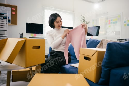 Preview: Startup owner unpacking clothes in new office