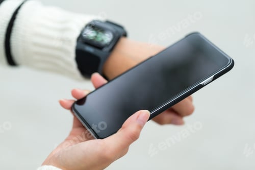 Preview: Woman connecting smart watch and cellphone