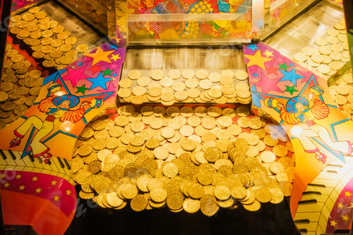 Preview: Golden tokens in a gaming machine in a casino.