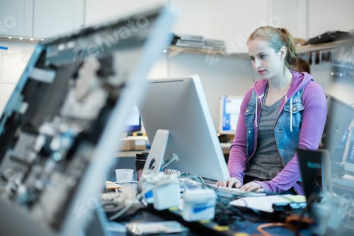 Preview: Computer Repair Shop. A woman standing typing at a keyboard.