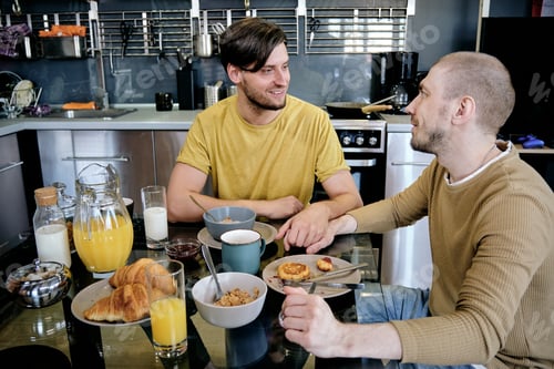 Preview: Two guys holding by hands during breakfast
