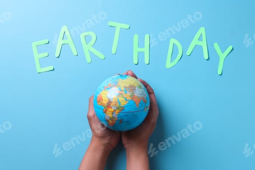 Preview: Globe on palms with earth day lettering