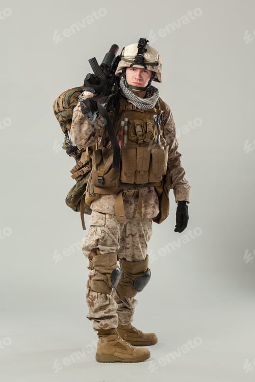 Preview: Soldier stands in uniform holding weapon with backpack ready for mission in plain setting