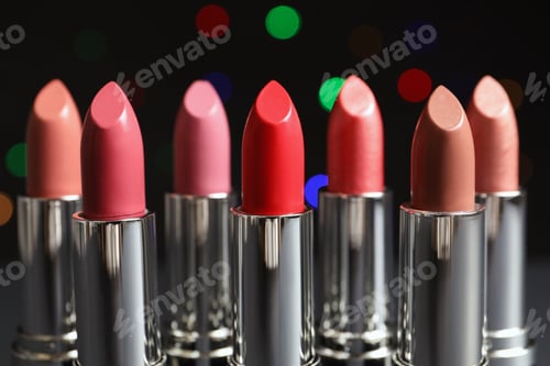 Preview: Different lipsticks against blurred lights. Cosmetic product