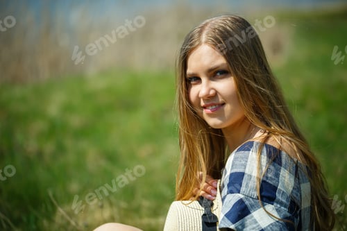 Preview: beautiful girl in a dress walking in the spring forest where the trees bloom