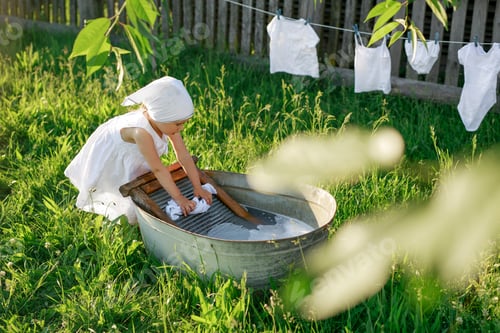 Preview: Girl in a kerchief and a dress launder snow-white linen by hand