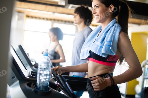 Preview: Fit people running in machine treadmill at fitness gym