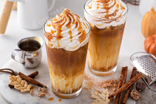 Preview: Iced pumpkin spice latte in tall glasses topped with whipped cream