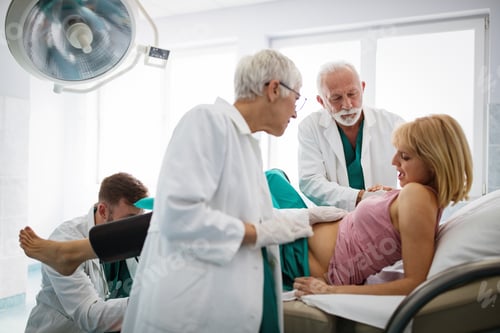 Preview: In the hospital woman in labor pushes to give birth, obstetricians assisting