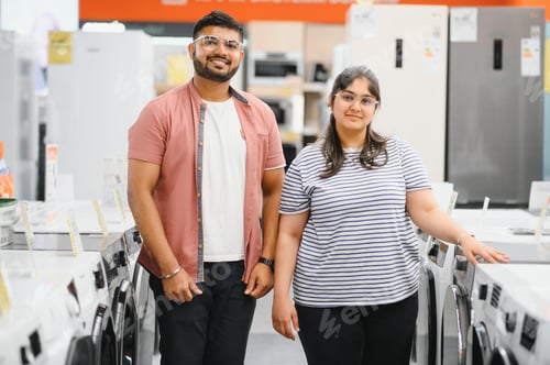 Preview: Young Multiethnic Couple Explores Home Electronics Store for Washing Machine Selection