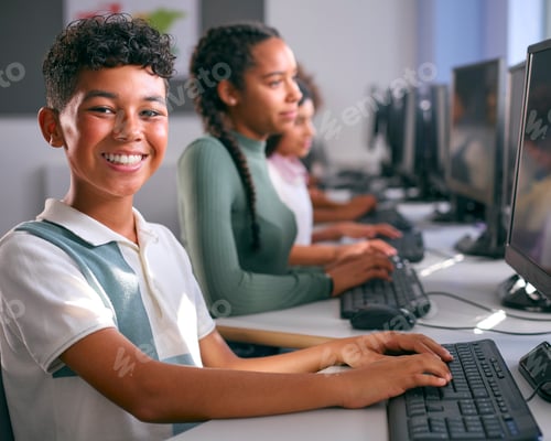Preview: Portrait Of Male Secondary Or High School Student Sitting At Computer Screen In IT Class