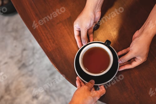 Preview: Close up of hands barista man serving coffee in coffee shop. male hands placing a cup of coffee