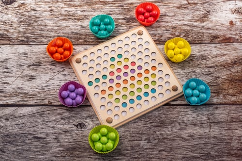 Preview: Wooden Montessori educational toy with multicolored spheres for preschool motor training.
