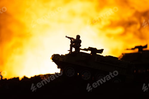 Preview: Silhouette of toy soldier on tank with fire at background, battle scene