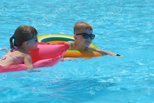 Preview: Young child girl relaxing on summer sun swimming on inflatable air mattress