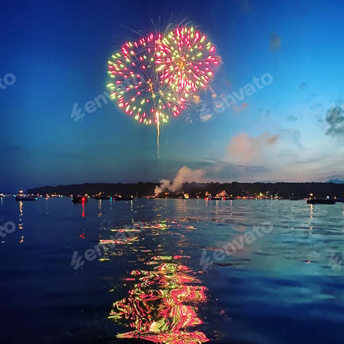 Preview: Colorful Fireworks are on display over the lake with beautiful reflections.