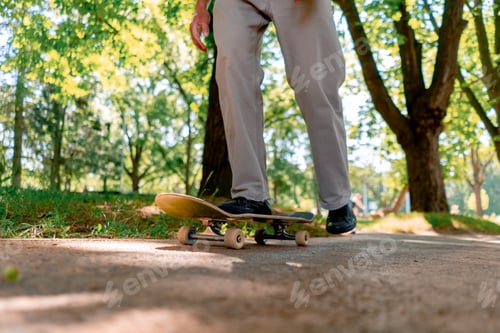 Preview: young guy skater rides skateboard on the path of the city park