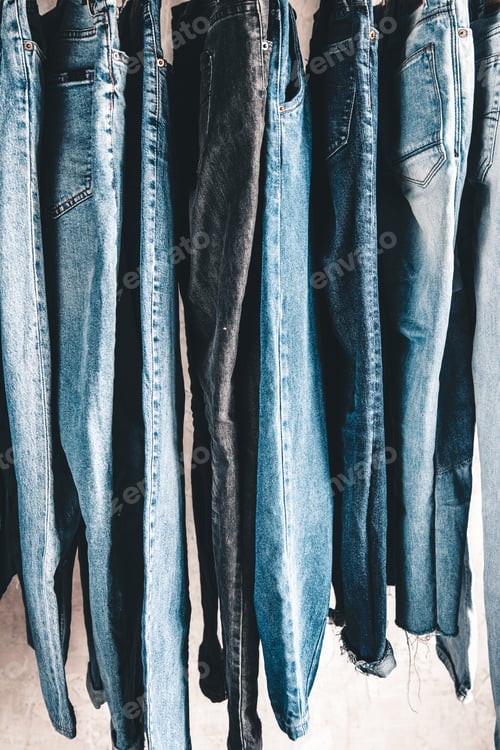 Preview: Rack with different jeans on grey background