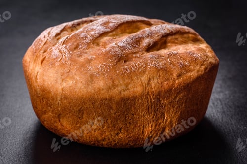 Preview: Tasty fresh baked in oven white bread on a dark concrete background