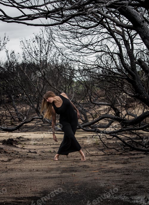 Preview: Woman dancing between dry trees