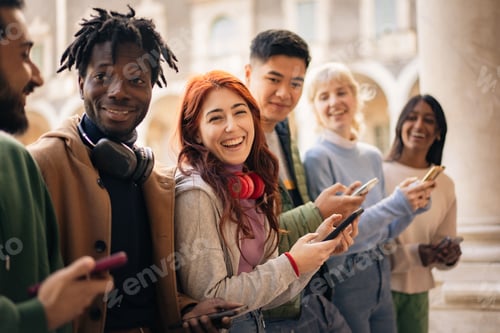 Preview: Diverse Group of University Students Using Smartphones and Laughing on Campus