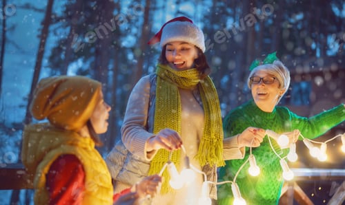 Preview: Cheerful Women with Child Decorating for Winter Holiday