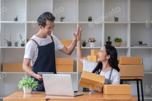 Preview: Two online sellers celebrate together in a room full of merchandise boxes as they meet their sales
