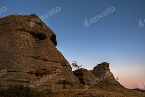 Preview: Sacred rocks, mountains in the shape of a head illuminated by the setting sun