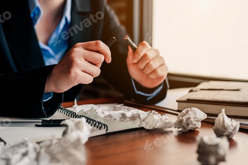 Preview: Angry business woman break pencil and crumpled paper on table at coffee shop.No idea concept.Busines