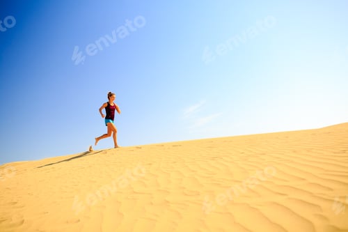 Preview: Young woman running on sand desert dunes