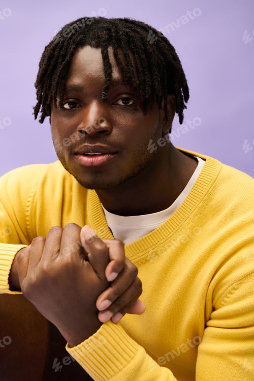 Preview: Handsome young man showcases stylish fashion with confident expression in playful setting