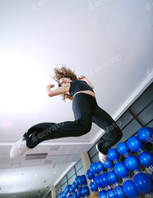 Preview: Dancing woman, happy and jumping up.