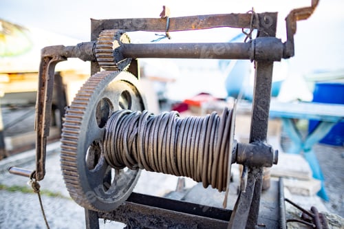 Preview: Winch with a rope on a pier with boats and boats against the sky