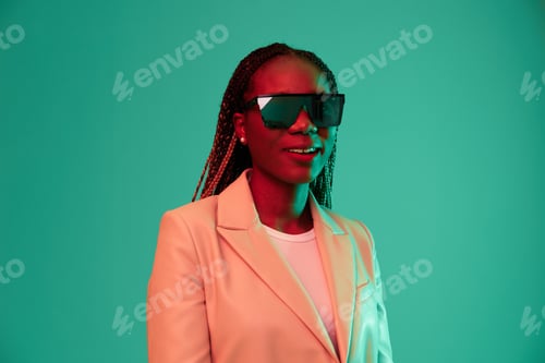 Preview: African american woman smile and fashion wearing glasses green background in neon light color mixed