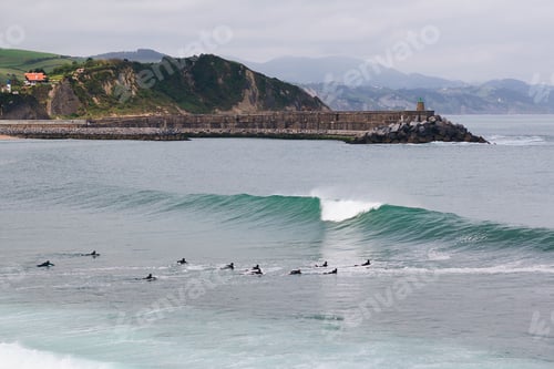 Preview: Aerial view of people surfing in the ocean