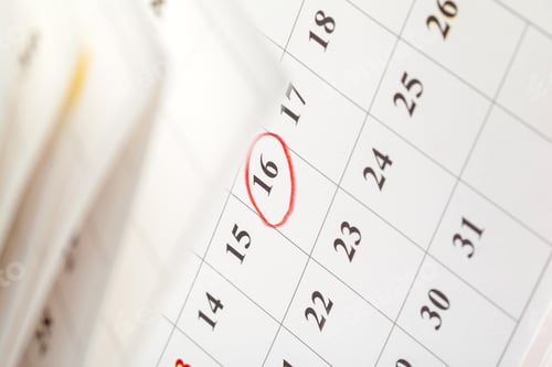 Preview: Marking an important date on a calendar in an office setting during daytime hours