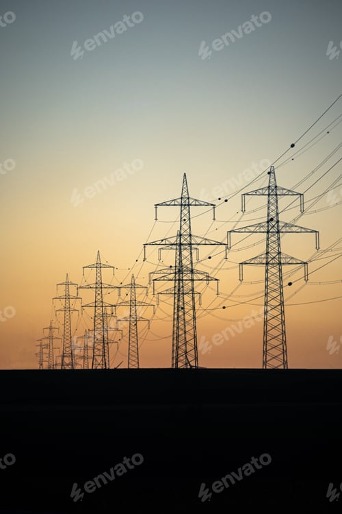 Preview: Vertical shot of electricity supplements line view with the orange sunset background