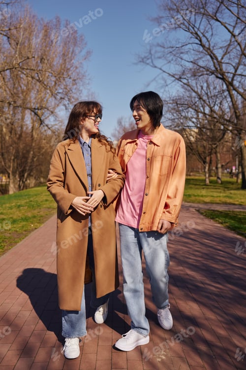 Preview: Multicultural friends enjoy a sunny day walking together in the park