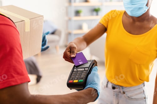 Preview: Cropped Shot Of Female Paying Courier With Credit Card, Indoor