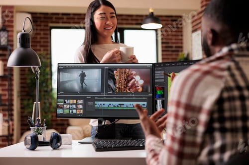Preview: People videographers editing film footage on computer