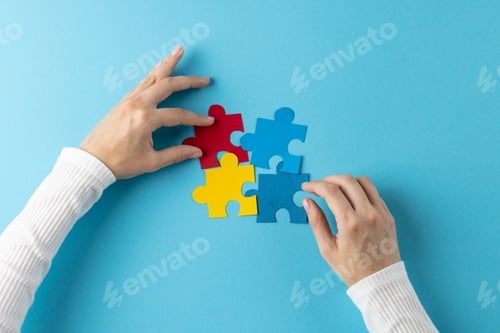Preview: Composition of hands putting jigsaw puzzle pieces together on blue background with copy space