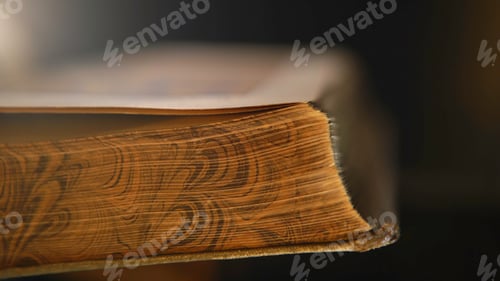 Preview: Close-up of unknown person holding in hands open old book and turning the pages. Stock footage