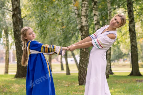 Preview: Caucasian mom and daughter are hugging while walking in nature. Mother and girl dancing