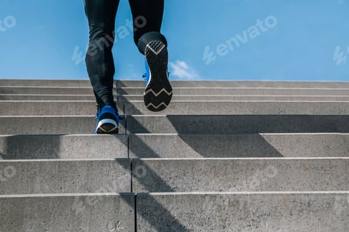 Preview: Young man exercising climbs stairs outdoors. Cut the view of strong and powerful legs