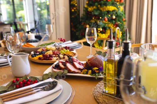Preview: Table with delicious meal prepared for christmas dinner in sunny dining room