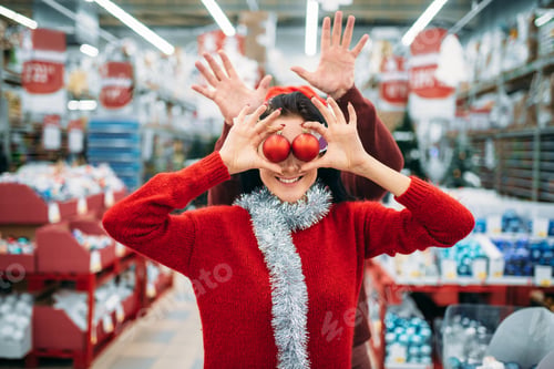 Preview: Couple chooses christmas tree balls in shop