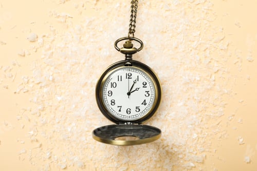Preview: Pocket watch with snow on a light background.