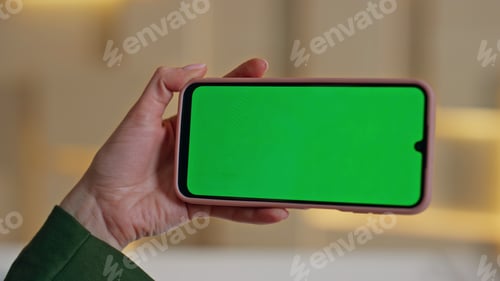 Preview: Unknown girl looking greenscreen cellphone in office closeup. Woman hand holding