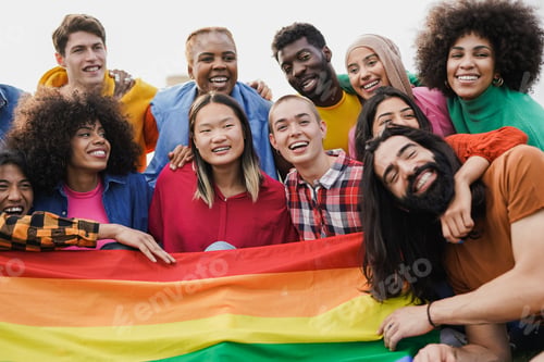 Preview: Group of multiracial young people having fun together outdoor with LGBT rainbow flag