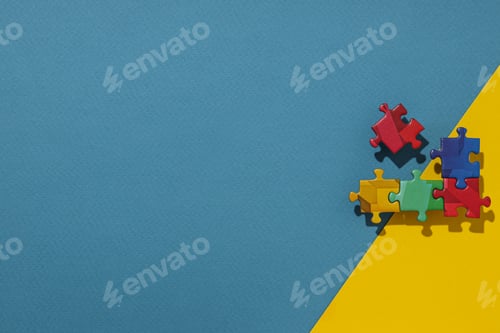 Preview: Multicolored puzzle pieces on a blue-yellow background. Place for text
